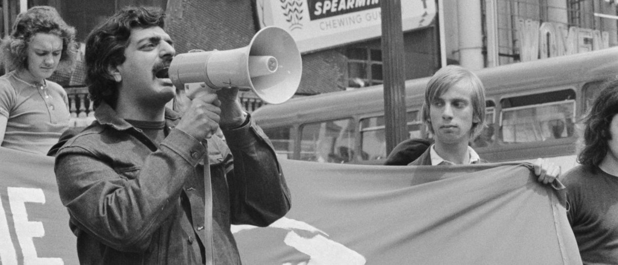 Street protest, megaphone — Tariq Ali at anti-Vietnam War rally, London, 1968. Public domain.
